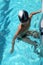 Boy swim in pool with blur transparent water