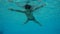 Boy swim in swimming pool, underwater slow motion