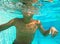 Boy swim under water in the pool