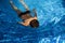 Boy swimming in blue pool