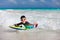 Boy swimming on boogie board