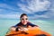 Boy swimming on boogie board