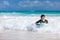 Boy swimming on boogie board