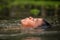 Boy swimming in the cannal near the Damnoen Saduak Floating Market