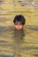 Boy swimming in the Holy River Ganges - India.