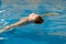 Boy swimming in indoor pool having fun during swim class