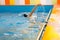 Boy swimming in indoor pool having fun during swim class