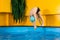 Boy swimming in indoor pool having fun during swim class