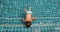 Boy swimming into outdoor swimming pool