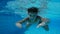 Boy in swimming pool swim underwater