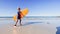 Boy in swimsuit wetsuit walk with surfboard to ocean