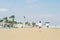 A boy in a T-shirt with sneakers on the sandy Mackenzie beach in Larnaca. Cyprus