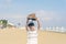 A boy in a T-shirt with sneakers on the sandy Mackenzie beach in Larnaca. Cyprus