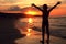 Boy takes a deep breath at the fiery sunset on the sea