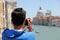 boy takes pictures at Basilica called Madonna della Salute in Ve
