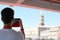 boy takes pictures at Bell tower of St Mark from the boat in Ven