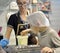 A boy takes a white chocolate mass for pouring into molds. Children`s excursion to the Belgostar chocolate factory