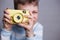 Boy taking a picture with vintage camera. Photography, hobby and