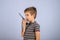 The boy is talking on the radio. A professional walkie-talkie in the child`s hand. The child speaks into a walkie-talkie on a blu