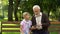 Boy teaching grandpa to use smartphone, new technologies difficult for pensioner