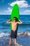 Boy teen surfer holding surfboard in the beach