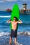 Boy teen surfer holding surfboard in the beach