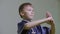 Boy teenager showing traditional greeting in wushu by holding fist. Martial arts