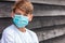 Boy teenager teen male child wearing face mask outside in the Coronavirus COVID-19 pandemic