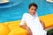 Boy teenager vacation holidays rest on pool float