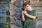 Boy teenager writes sms standing by awooden wall