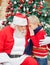 Boy Telling Wish In Santa Claus\'s Ear
