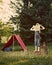 Boy with tent in meadow