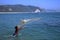 Boy throwing the fishnet into the ocean, pacific coast, Mexico