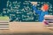 Boy throwing paper planes and wooden table with book stack, with