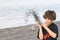 Boy throwing shingle on beach