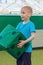 Boy throws large green cube. Active kinds of games.