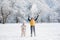 Boy throws snow above the head being near the girl