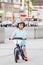 Boy toddler riding a balance bike bicycle in helmet on the road
