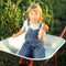 Boy with a tomato garden in a wheelbarrow