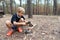 Boy at a tourist camp prepares firewood to make a fire