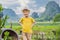 Boy tourist on top pagoda of Hang Mua temple, rice fields, Ninh Binh, Vietnam. Vietnam reopens borders after quarantine