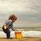 Boy with toy trowel bucket