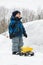 Boy with Toy Truck beside Deep Snowbank