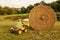 Boy on tractor lifting hay bale