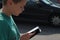 Boy in traffic looking at mobile phone