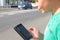 Boy in traffic looking at mobile phone