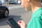 Boy in traffic looking at mobile phone