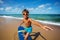 Boy training to stand on a surfboard at the beach