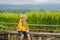 Boy traveler on Beautiful Jatiluwih Rice Terraces against the background of famous volcanoes in Bali, Indonesia