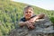 A boy traveler climbed to the top of the cliff